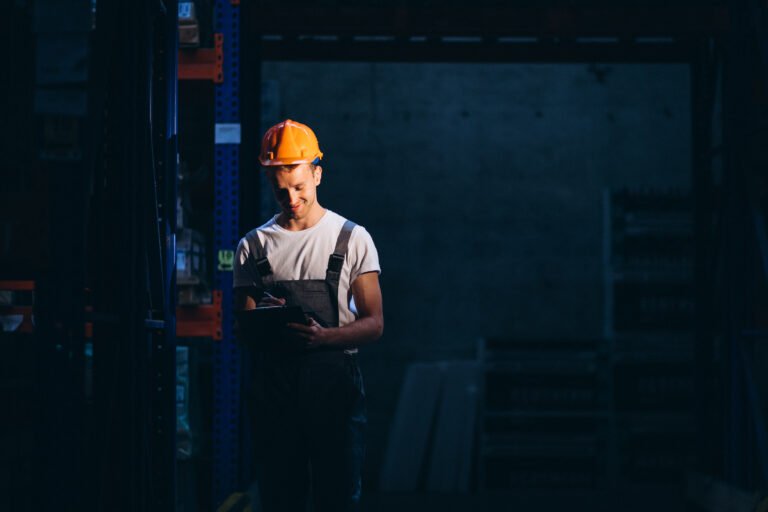 Young man working at a warehouse with boxes